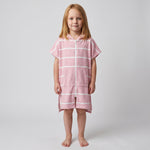 Amalfi kids hooded towel in pink and white stripes worn by a young girl, studio photo, front view