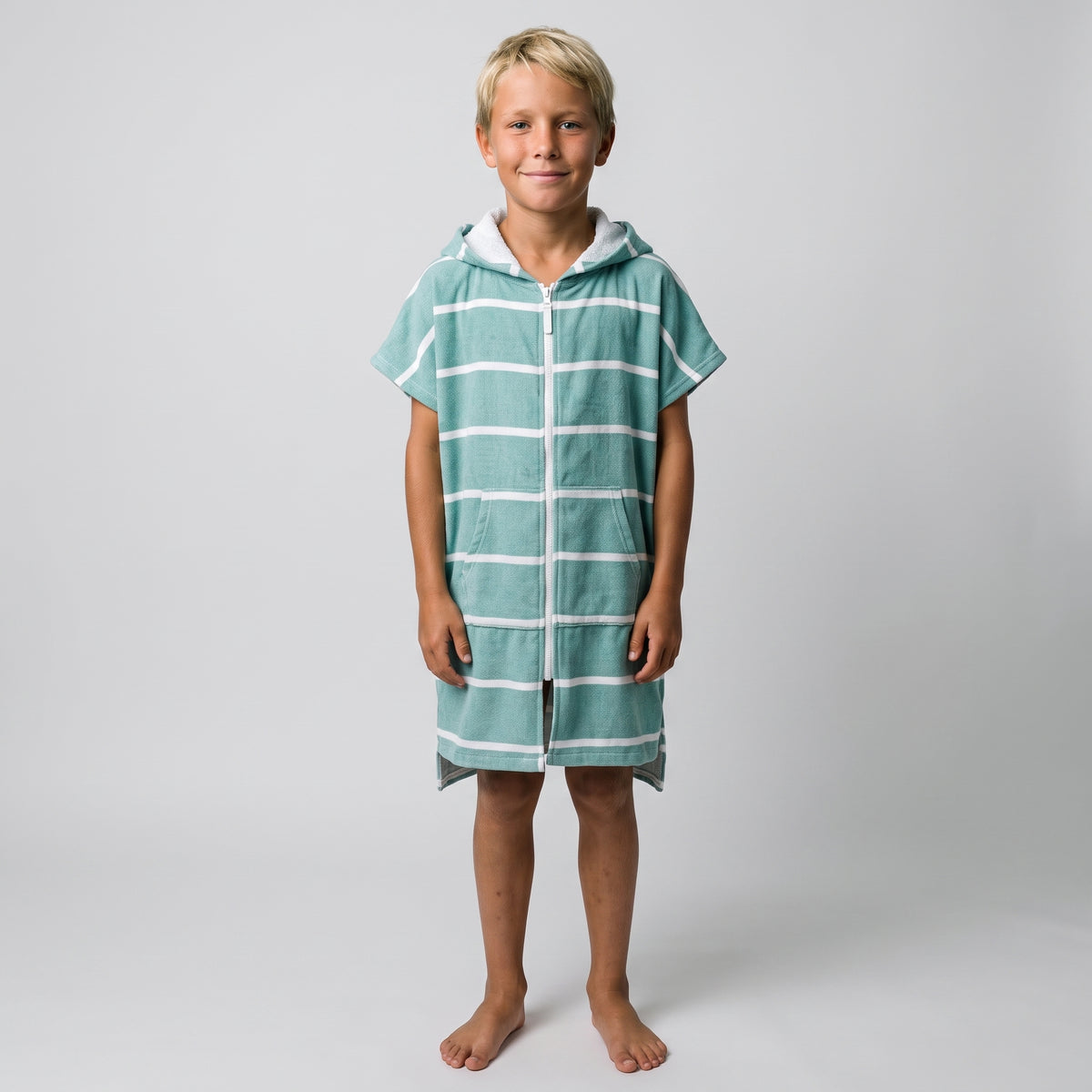 Amalfi kids hooded towel in teal and white stripes worn by a boy, studio photo, front view