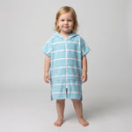 Amalfi toddler hooded towel in aqua and white stripes worn by a toddler girl, studio photo, front view
