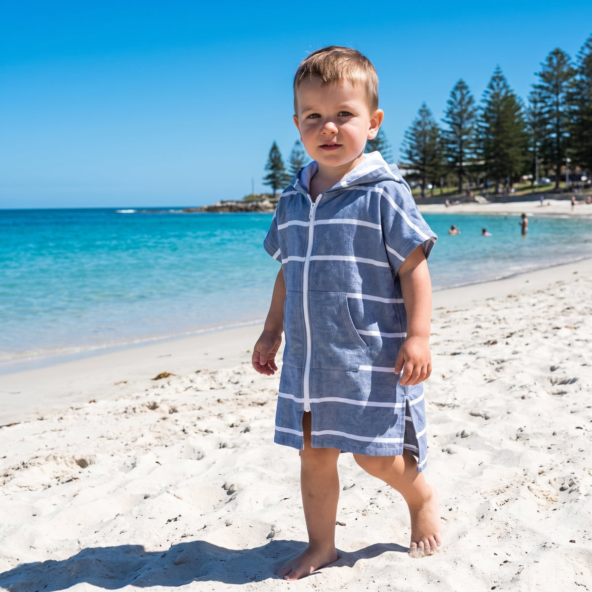Toddler boy in the Amalfi navy and white toddler zip hooded towel, on Cottesloe Beach, Perth