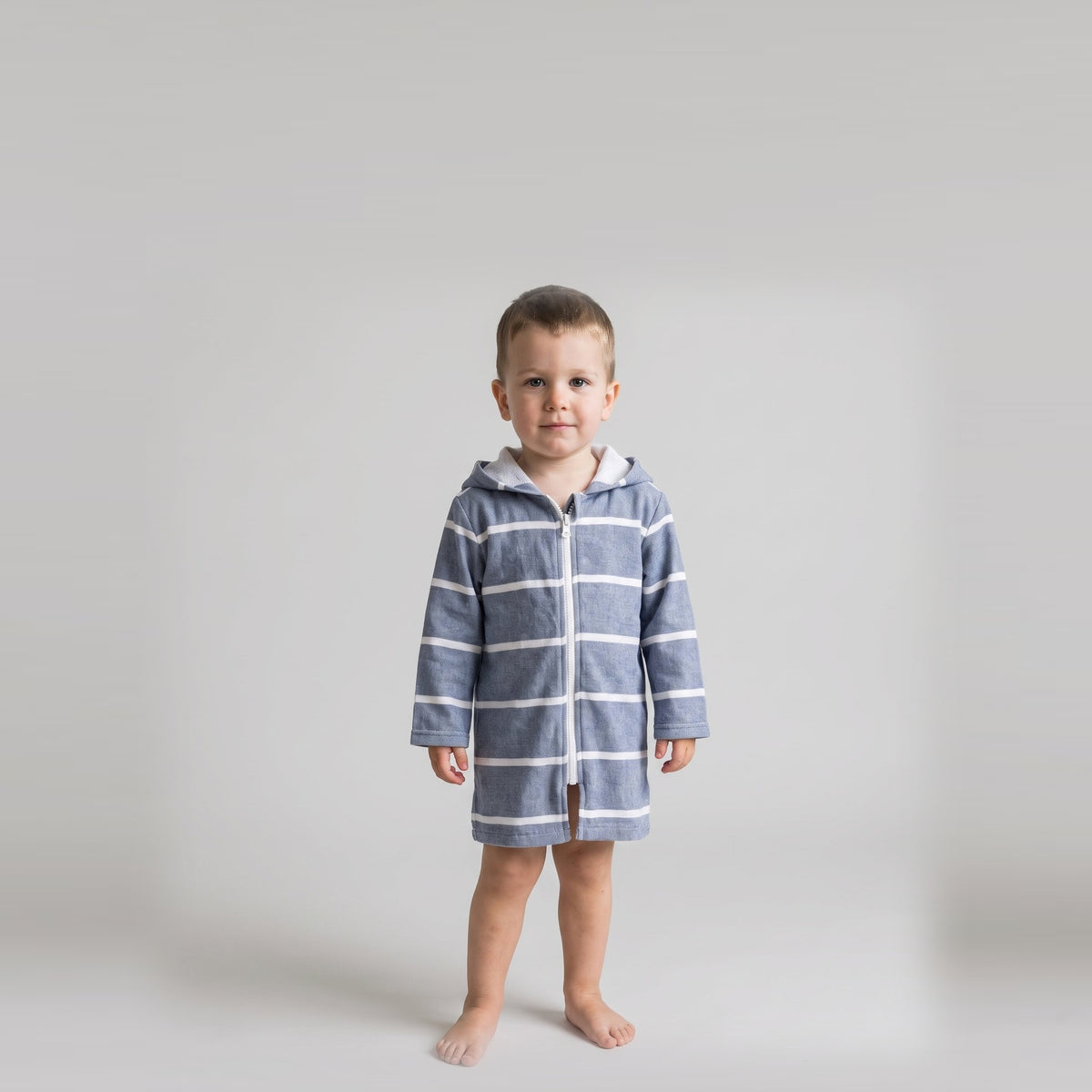 Toddler boy in the long sleeve Amalfi navy and white toddler hooded towel, studio front view