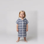 Amalfi toddler hooded towel in navy and white stripes worn by a toddler girl, studio photo, front view