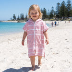 Toddler girl in the Amalfi pink and white toddler zip hooded towel, on Cottesloe Beach, Perth