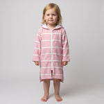 Toddler girl in the long sleeve Amalfi pink and white toddler hooded towel, studio front view