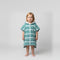 Toddler girl wearing Amalfi teal and white striped toddler hooded towel, studio photo, front view