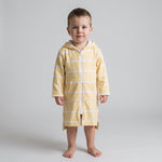 Toddler boy wearing the long sleeve Amalfi yellow and white toddler hooded towel, studio front view