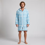 Man wearing the long sleeve Amalfi aqua and white striped adult hooded towel, studio front view
