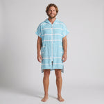 Man wearing the Amalfi Aqua White Turkish hooded towel, front view on a plain studio background