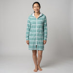 Woman in the long sleeve Amalfi teal and white striped adult hooded towel, studio front view