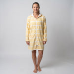 Woman wearing the long sleeve Amalfi yellow and white striped adult hooded towel, studio front view