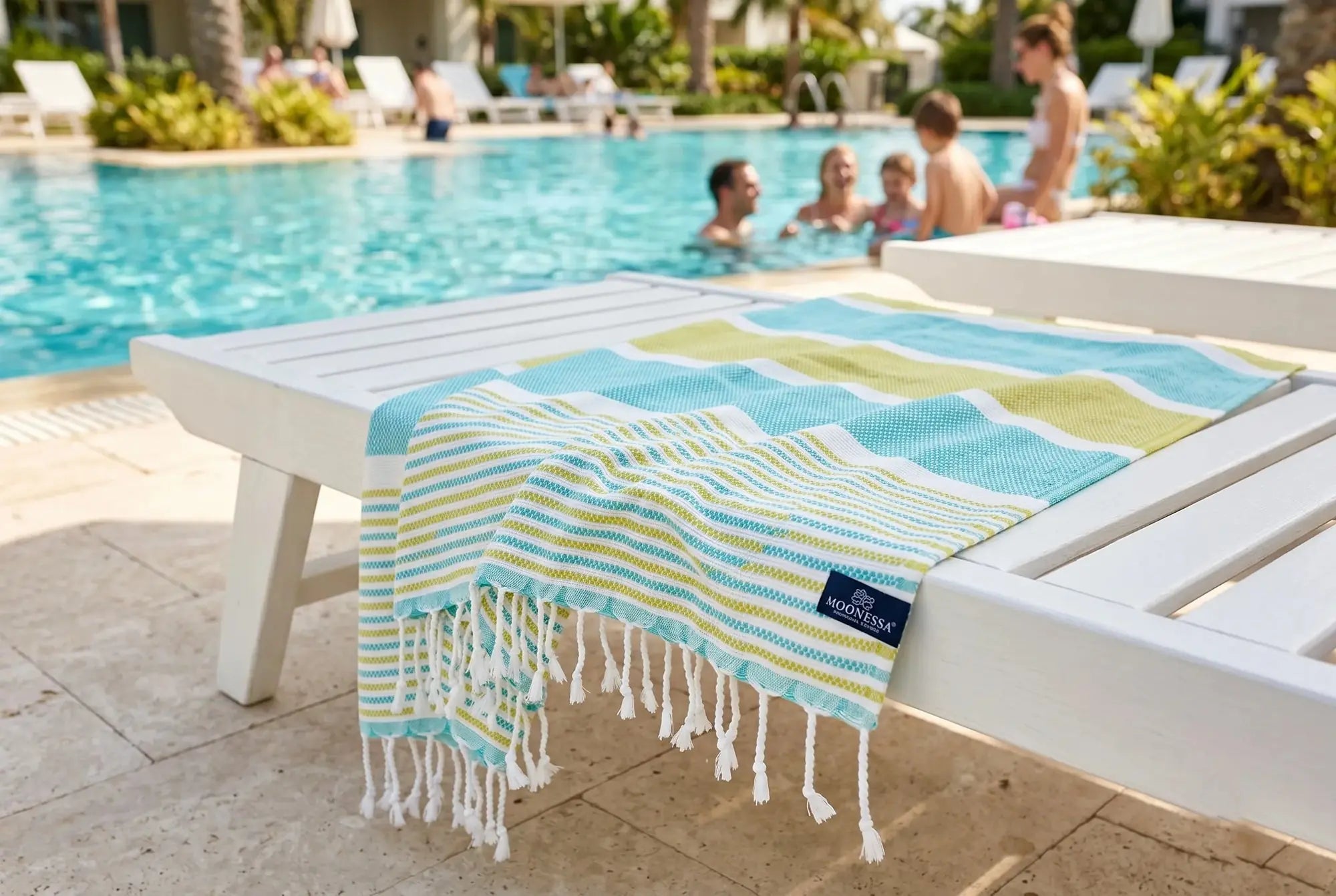 Gold Coast mint and mustard midweight Turkish towel beside a swimming pool