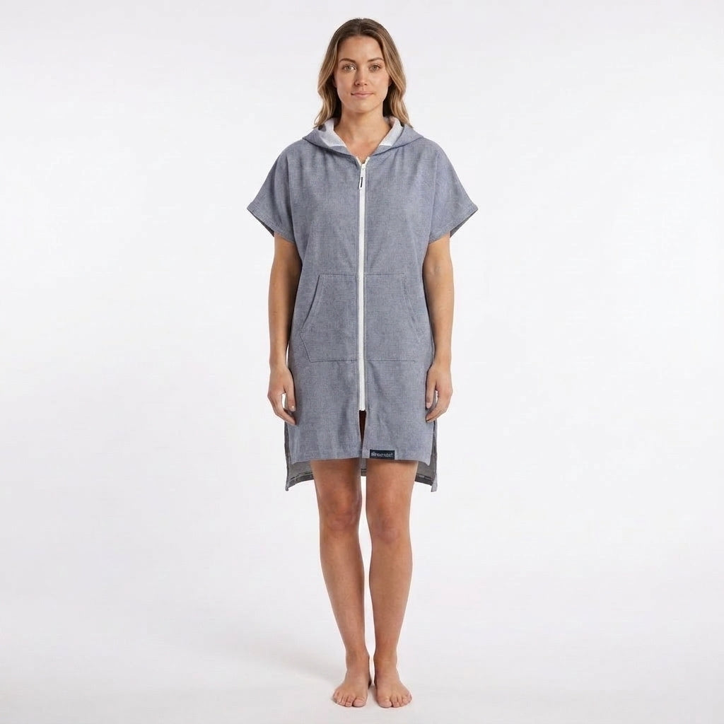 Woman wearing the Santorini Navy Turkish hooded towel, front view on a plain studio background showing the hood and front pocket