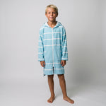 Long sleeve Amalfi kids hooded towel in aqua and white stripes worn by a boy, studio front view