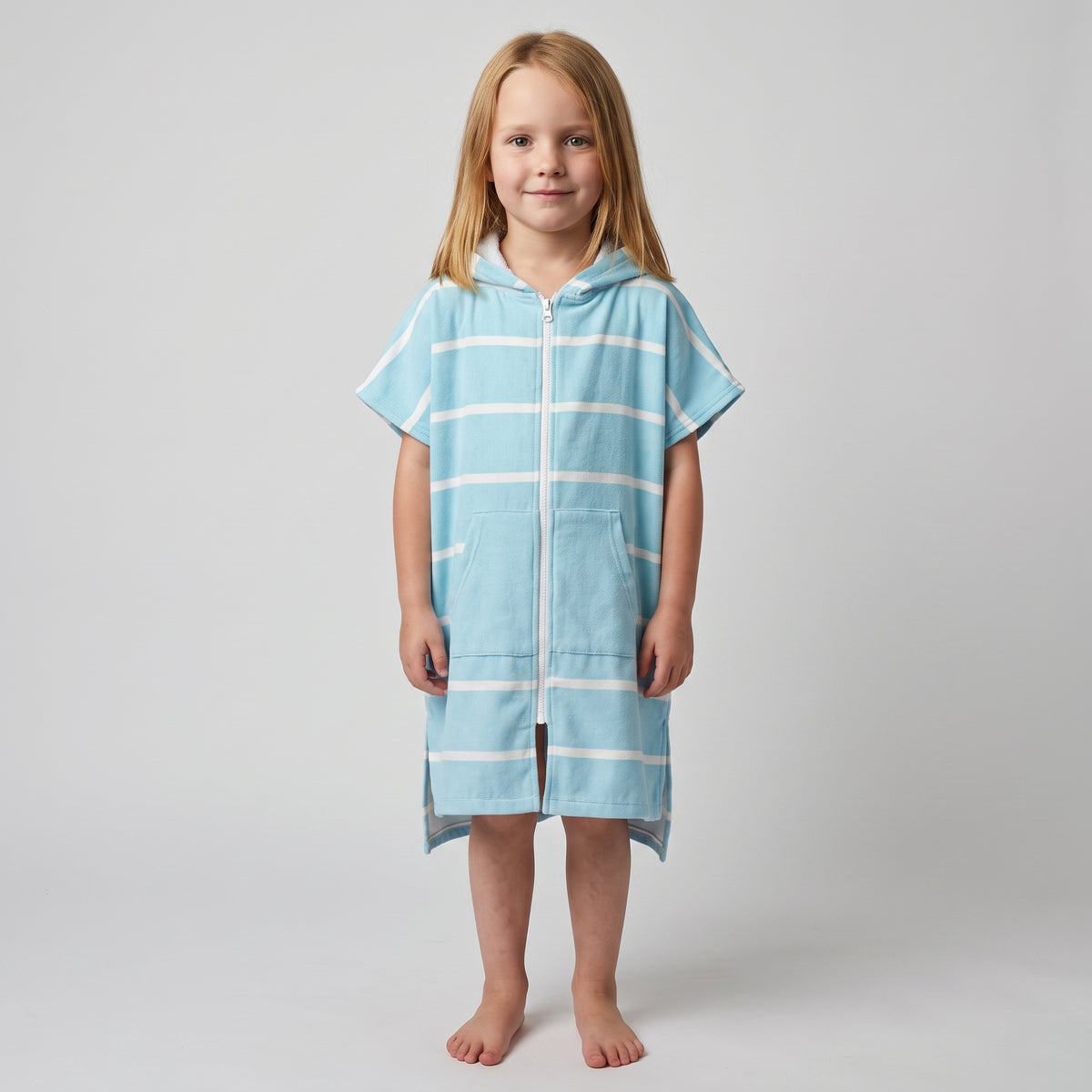 Young girl wearing Amalfi aqua and white striped kids hooded towel, studio photo, front view