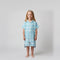 Young girl wearing Amalfi aqua and white striped kids hooded towel, studio photo, front view