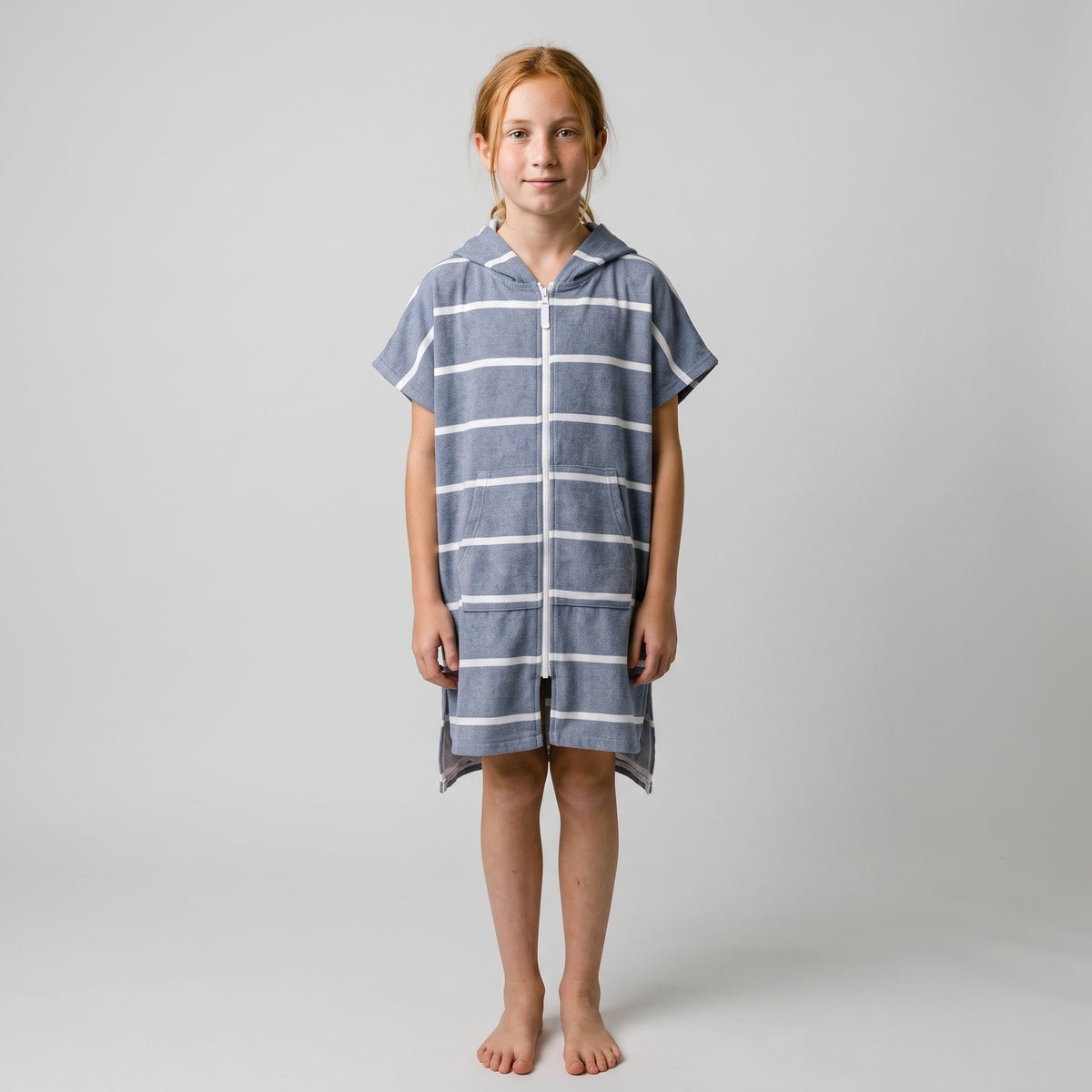 Girl in the Amalfi navy and white kids zip hooded towel, studio photo, front view