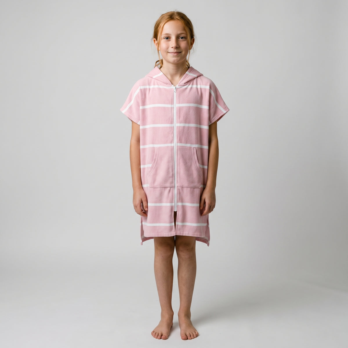 Girl in the Amalfi pink and white kids zip hooded towel, studio photo, front view
