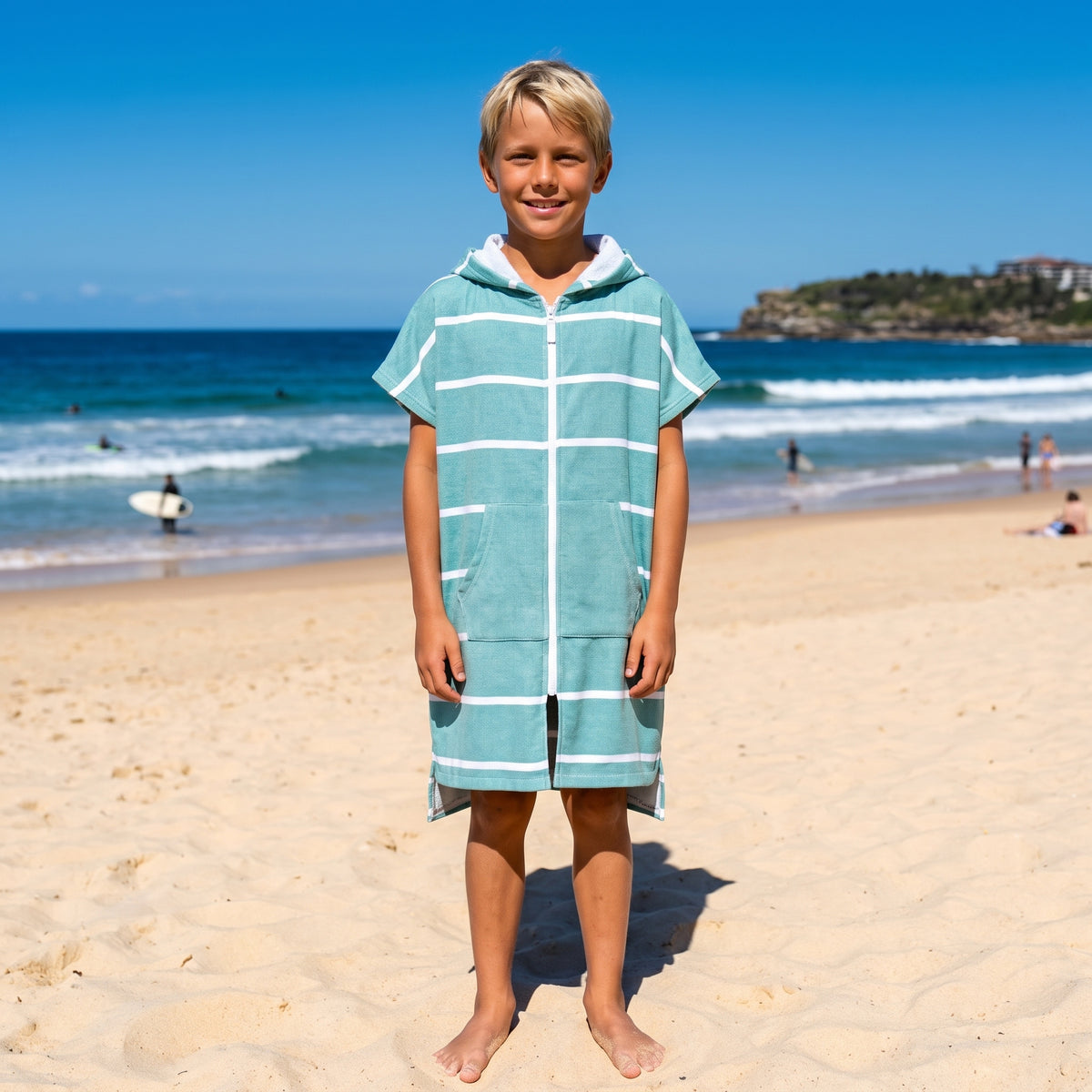 Boy in the Amalfi teal and white kids zip hooded towel, on Bondi Beach, Sydney