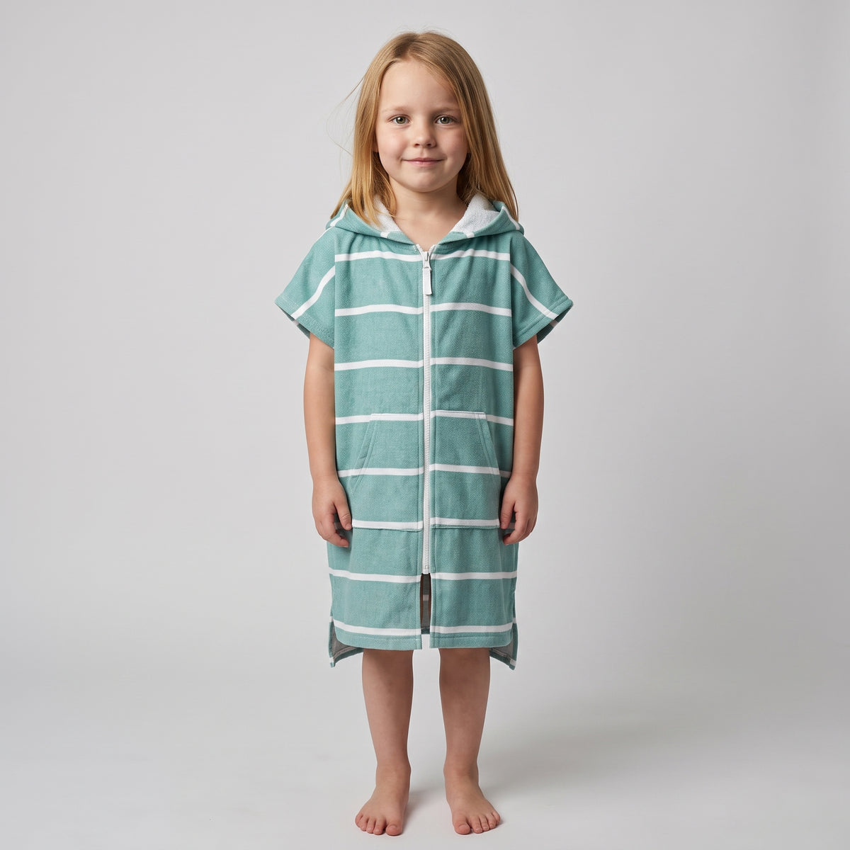 Young girl wearing Amalfi teal and white striped kids hooded towel, studio photo, front view