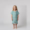 Young girl wearing Amalfi teal and white striped kids hooded towel, studio photo, front view
