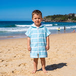Toddler boy in the Amalfi aqua and white toddler zip hooded towel, on Bondi Beach, Sydney