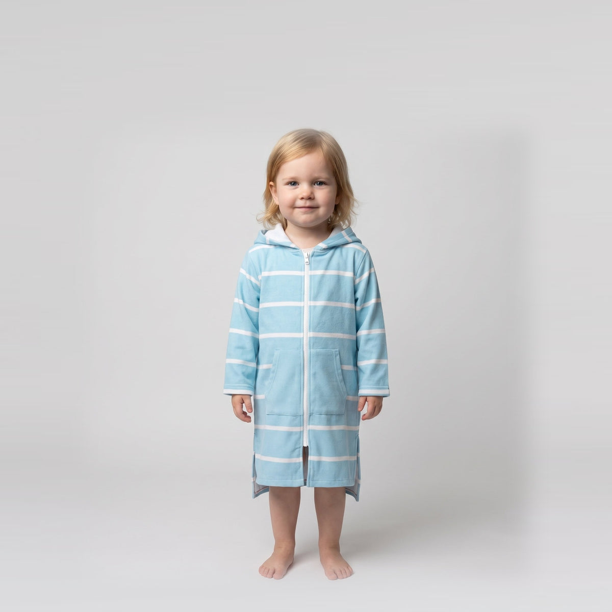 Toddler girl in the long sleeve Amalfi aqua and white toddler hooded towel, studio front view