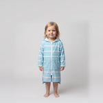 Toddler girl in the long sleeve Amalfi aqua and white toddler hooded towel, studio front view