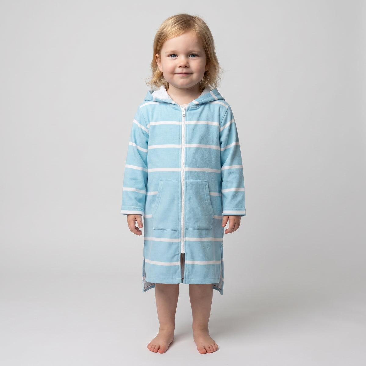 Toddler girl in the long sleeve Amalfi aqua and white toddler hooded towel, studio front view