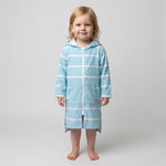 Toddler girl in the long sleeve Amalfi aqua and white toddler hooded towel, studio front view
