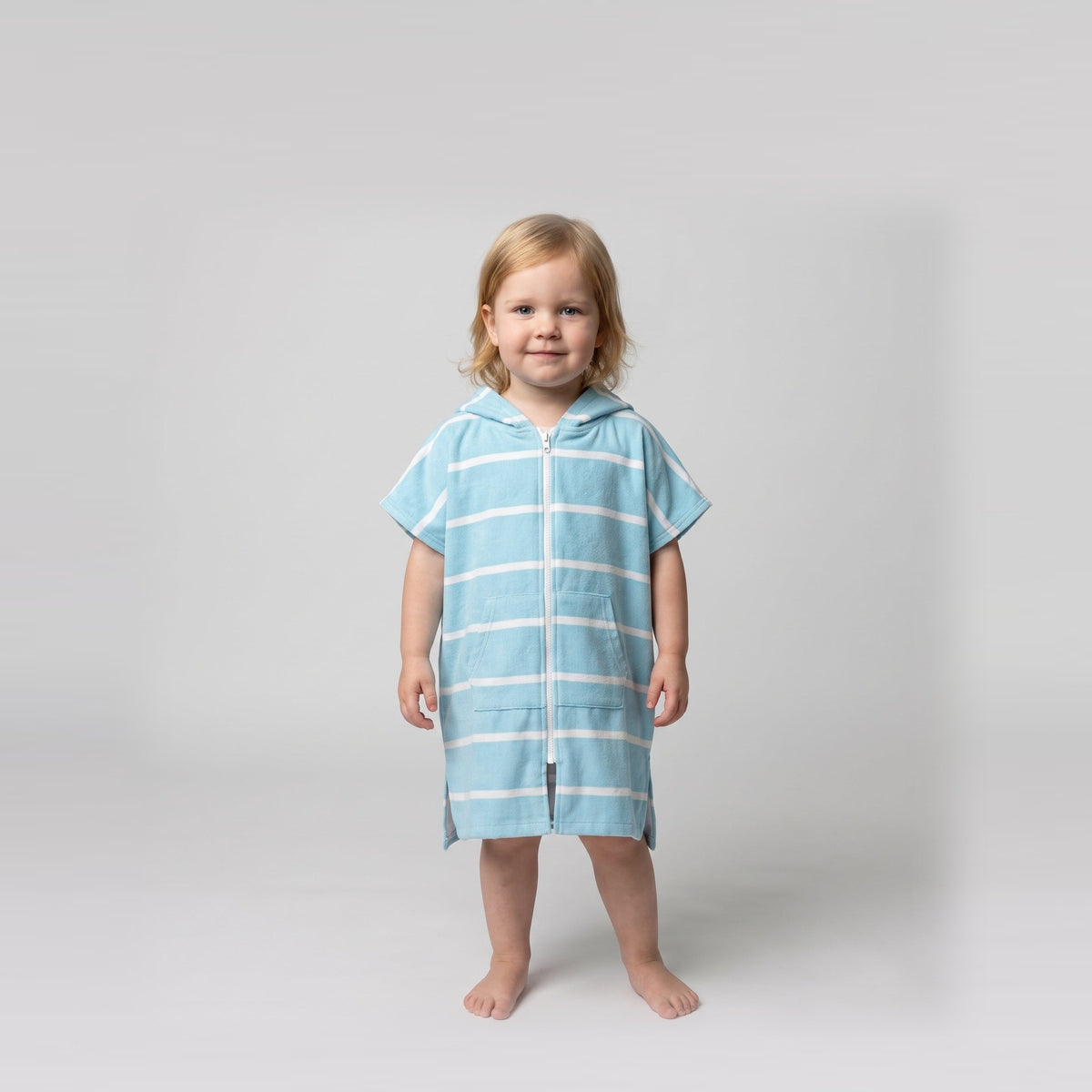 Amalfi toddler hooded towel in aqua and white stripes worn by a toddler girl, studio photo, front view