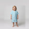 Amalfi toddler hooded towel in aqua and white stripes worn by a toddler girl, studio photo, front view