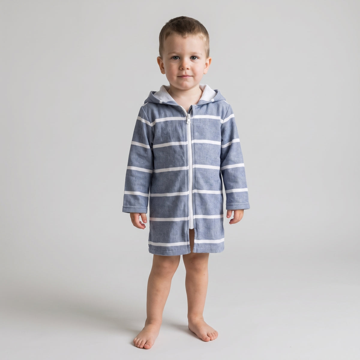 Toddler boy in the long sleeve Amalfi navy and white toddler hooded towel, studio front view