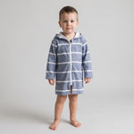 Toddler boy in the long sleeve Amalfi navy and white toddler hooded towel, studio front view