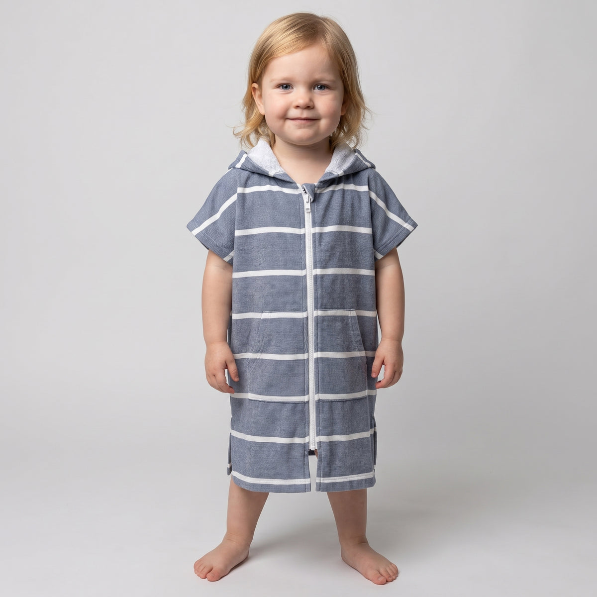 Amalfi toddler hooded towel in navy and white stripes worn by a toddler girl, studio photo, front view
