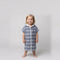 Amalfi toddler hooded towel in navy and white stripes worn by a toddler girl, studio photo, front view