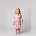 Toddler girl in the long sleeve Amalfi pink and white toddler hooded towel, studio front view