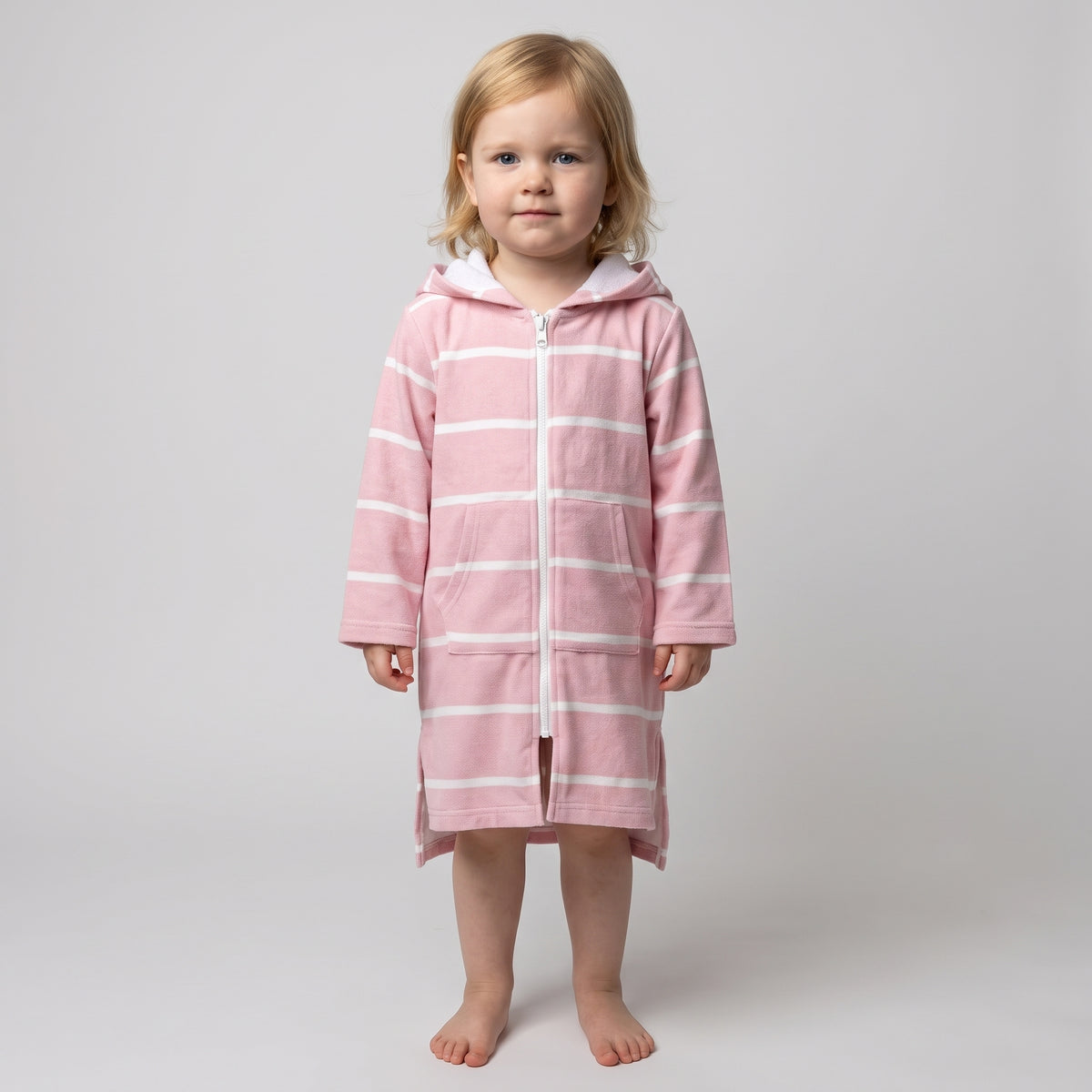 Toddler girl in the long sleeve Amalfi pink and white toddler hooded towel, studio front view