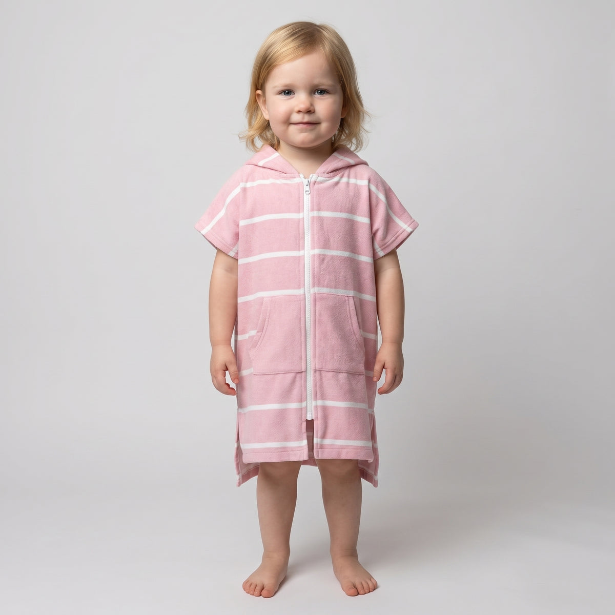 Amalfi toddler hooded towel in pink and white stripes worn by a toddler girl, studio photo, front view