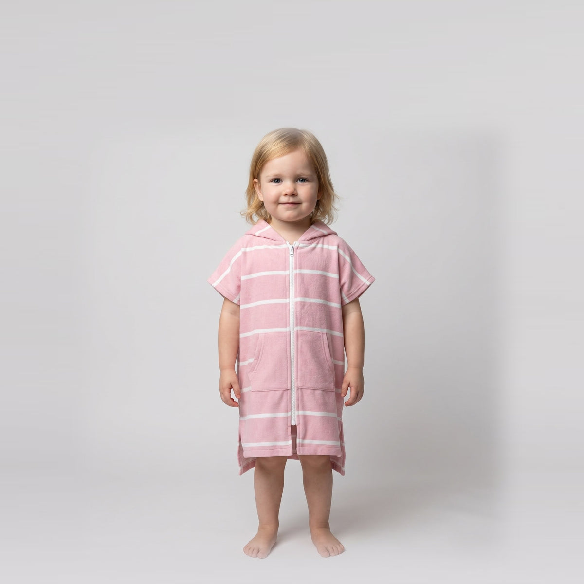 Amalfi toddler hooded towel in pink and white stripes worn by a toddler girl, studio photo, front view