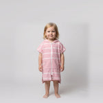 Amalfi toddler hooded towel in pink and white stripes worn by a toddler girl, studio photo, front view