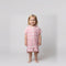 Amalfi toddler hooded towel in pink and white stripes worn by a toddler girl, studio photo, front view