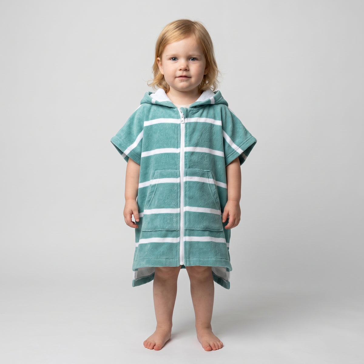Toddler girl wearing Amalfi teal and white striped toddler hooded towel, studio photo, front view