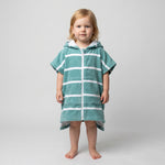 Toddler girl wearing Amalfi teal and white striped toddler hooded towel, studio photo, front view