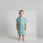 Amalfi toddler hooded towel in teal and white stripes worn by a toddler boy, studio photo, front view