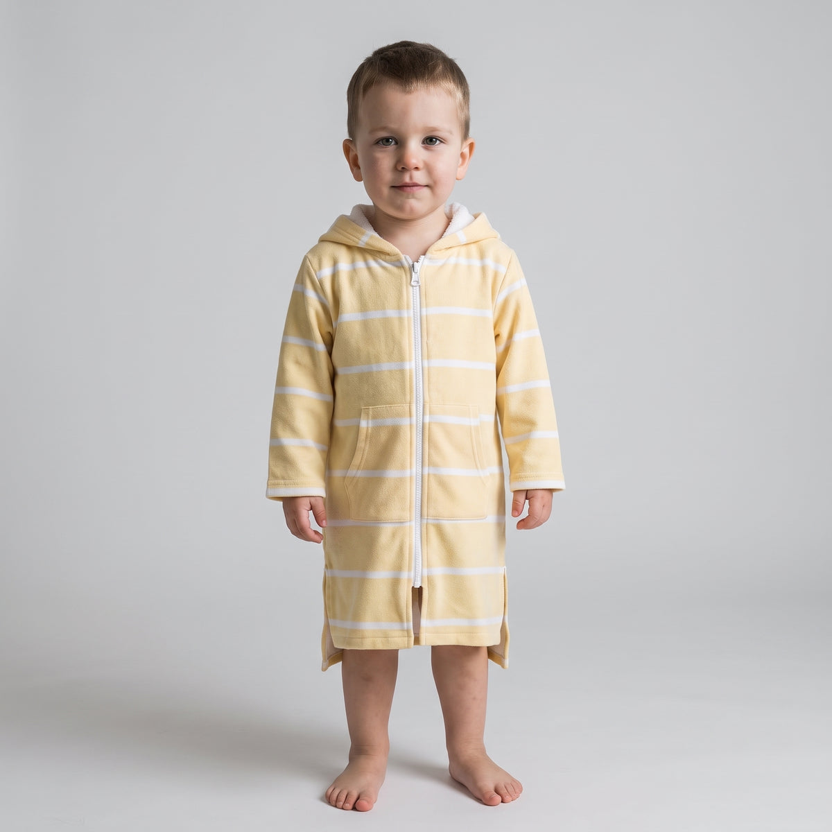 Toddler boy wearing the long sleeve Amalfi yellow and white toddler hooded towel, studio front view