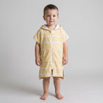 Toddler boy in the Amalfi yellow and white toddler zip hooded towel, studio photo, front view