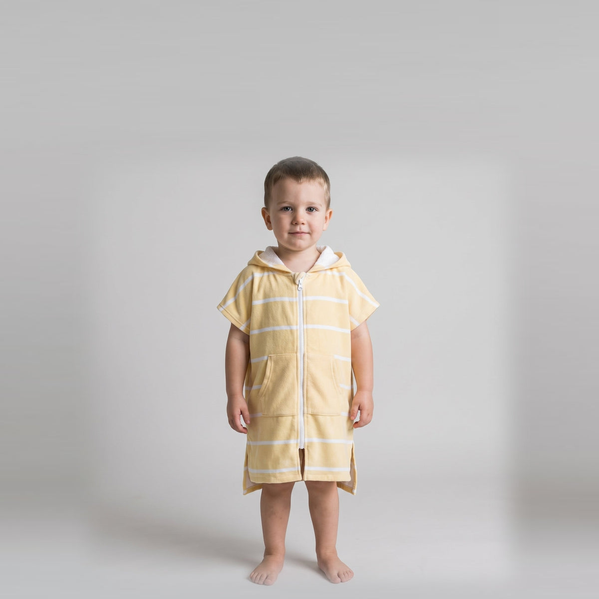 Toddler boy in the Amalfi yellow and white toddler zip hooded towel, studio photo, front view
