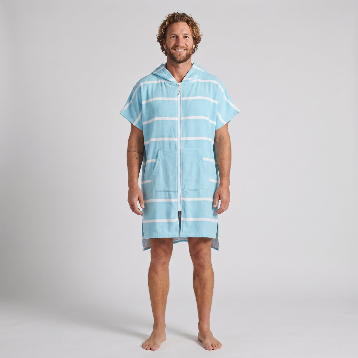 Man wearing the Amalfi Aqua White Turkish hooded towel, front view on a plain studio background