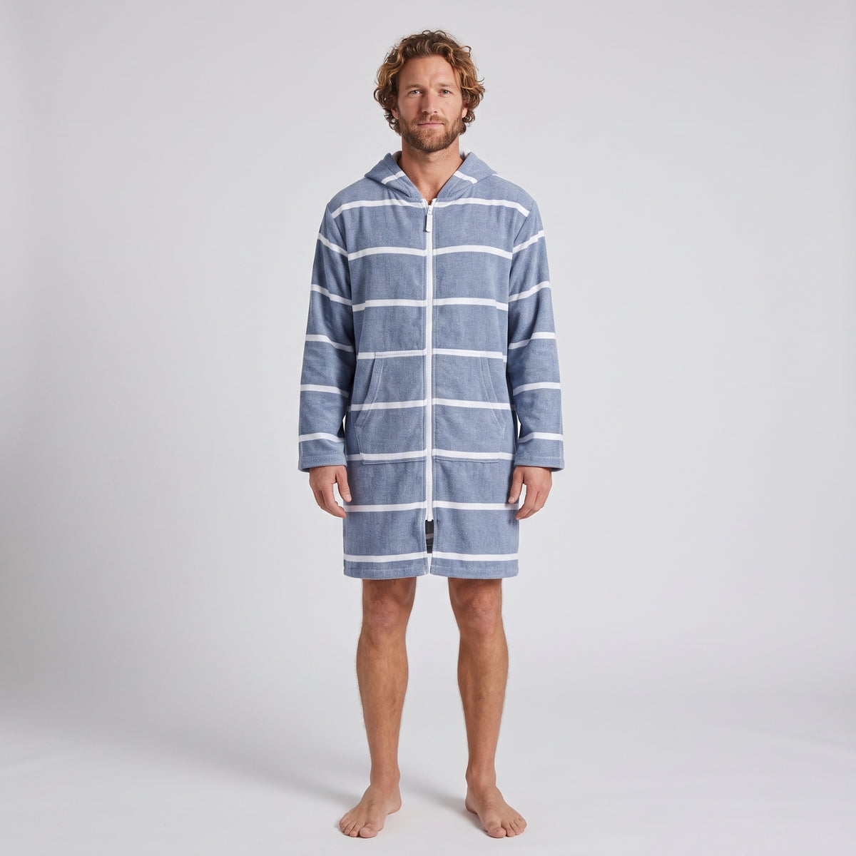 Long sleeve Amalfi adult hooded towel in navy and white stripes worn by a man, studio front view