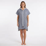Woman wearing the Santorini Navy Turkish hooded towel, front view on a plain studio background showing the hood and front pocket